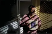  ?? NATACHA PISARENKO — THE ASSOCIATED PRESS ?? Pedro Alejandro Sandoval holds a photo of his biological mother Liliana Fontana, in Buenos Aires, Argentina, on Aug. 7, 2023.