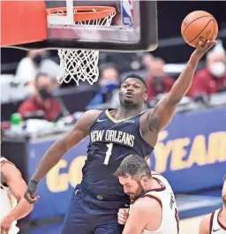  ?? DAVID RICHARD/USA TODAY SPORTS ?? The Pelicans’ Zion Williamson goes to the basket against Cavaliers forward Kevin Love on Sunday in Cleveland.