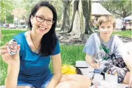  ?? SUSAN JACOBSON/STAFF ?? Sanford Rocks founder Lori Griffin, 42, and her son Jacob Czerwinski, 12, show off the rocks they painted at the group’s summer meetup last week. Griffin started the group in 2016.