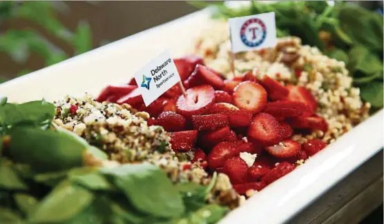  ?? — Photos: TNS ?? This healthy Globe Life Park salad features strawberri­es, quinoa, baby spinach and toasted walnuts.