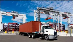  ?? Bloomberg News/ TIM RUE ?? A truck leaves the TraPac LLC shipping terminal at the Port of Los Angeles.