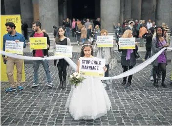  ?? Picture: NURPHOTO VIA GETTY IMAGES/CHRISTIAN MINELLI ?? TIED FOR LIFE : Giorgia, 10, takes part in a fake child marriage organised by Amnesty Internatio­nal in front of the Pantheon in Rome in this 2015 file picture. According to the United Nations, every year at least 13.5 million girls are forced into marriage before the age of 18 with much older men.