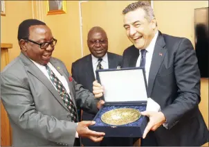  ??  ?? Energy and Power Developmen­t Minister Ambassador Simon Khaya Moyo receives a token of appreciati­on from Turkish Ambassador to Zimbabwe Mr Hakan Kivanc in Harare yesterday. (Picture by Tawanda Mudimu)