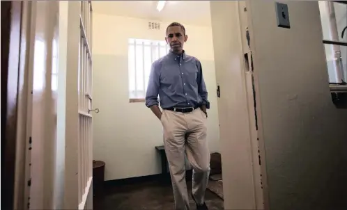  ?? PICTURE: AP/AFRICAN NEWS AGENCY (ANA) ?? In this 2013 file picture, then US president Barack Obama walks from Section B, prison cell No 5, where Nelson Mandela spent 18 of his 27-year prison term on Robben Island. Obama will use his upcoming Nelson Mandela Lecture to motivate a new generation...