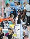  ??  ?? North Carolina forward Theo Pinson takes part in the ceremonial net cutting.