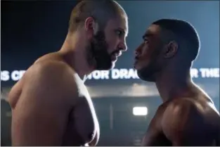  ?? BARRY WETCHER — METRO GOLDWYN MAYER PICTURES/WARNER BROS. PICTURES VIA AP ?? This image released by Metro Goldwyn Mayer Pictures / Warner Bros. Pictures shows Florian Munteanu , left, and Michael B. Jordan in a scene from “Creed II.”