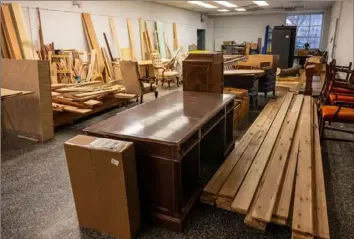  ?? ?? Stacks of wood and furniture are piled up for use in the workshop at the College of St. Joseph the Worker in Steubenvil­le, Ohio, last month. The workshop is open to the community.