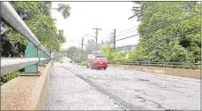  ?? Hearst Connecticu­t Media file photo ?? A car drives over the Holabird Avenue bridge in Winsted.