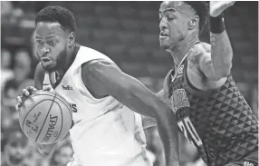  ?? COMMERCIAL APPEAL MARK WEBER, THE ?? Memphis Grizzlies forward JaMychal Green (left) drives the lane against Atlanta Hawks defender John Collins (right) during first quarter action at the FedExForum in Memphis, Tenn., Friday, October 5, 2018.