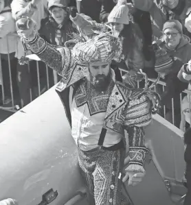  ?? JENNIFER CORBETT/WILMINGTON NEWS JOURNAL ?? Eagles center Jason Kelce celebrates with fans while dressed in a Mummers outfit and riding in a parade celebratin­g the Super Bowl victory.