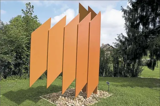  ?? Darrell Sapp/Post-Gazette photos ?? “Soaring Form in Orange,” a 1992 sculpture by the late Josefa Filkosky, an artist and Seton Hill University professor, is part of the new Sculpture Park addition to the Southern Alleghenie­s Museum of Art Ligonier Valley.