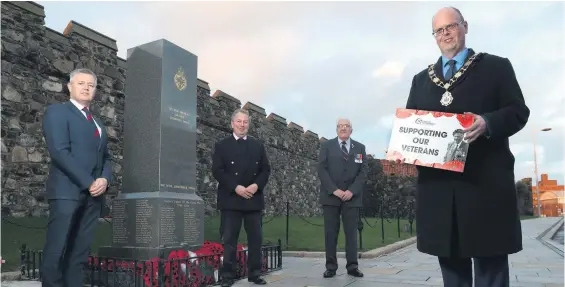  ??  ?? Contributi­on: Mayor Jim Montgomery with councillor Paul Michael, Veterans’ Commission­er Danny Kinahan and ex-serviceman Ron Harrison