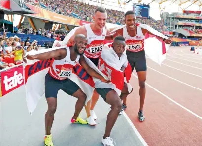  ?? AFP ?? (Left to right) Gold medallists England’s Reuben Arthur, Richard Kilty, Zharnel Hughes and Harry Aikines-Aryeetey celebrate winning the athletics men’s 4x100m relay final. —