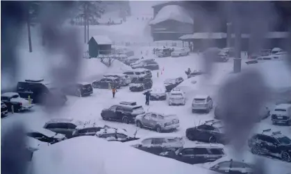  ?? Photograph: John Locher/AP ?? The parking area at Palisades Tahoe during a winter storm on 24 February 2023, in Alpine Meadows, California.