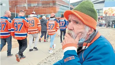  ?? ?? Curtis Smith panhandles outside of Rogers Place during an Oilers playoff game. He says the worst that’s happened is someone once came and kicked his money holder on the ground.
