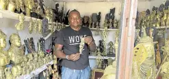  ?? —REUTERS ?? ON OFFER Edosonmwan William, a bronze caster, shows one of his works at his gallery on Igun Street, Benin City, in Nigeria on Aug. 24.