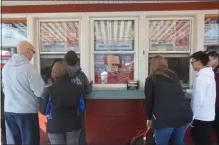  ??  ?? Customers order ice cream on opening day of Snowman Ic Cream’s 2020 season.