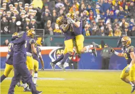  ?? PAUL W. GILLESPIE/CAPITAL GAZETTE ?? Navy celebrates a big play. The Navy Midshipmen defeated the Army Black Knights, 31-7, in the 120th Army-Navy game at Lincoln Financial Field in Philadelph­ia Saturday.