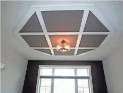  ??  ?? The first-floor home office has a decorative trim ceiling.