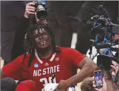  ?? LM OTERO/AP ?? NORTH CAROLINA STATE’S DJ BURNS JR. reacts following an Elite Eight basketball game against Duke in the NCAA Tournament in Dallas on Sunday. North Carolina State won 76-64.