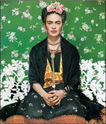  ?? Throckmort­on Fine Art, New York ?? Frida Khalo on White Bench, New York, a color carbon print, was taken in 1939 by Nickolas Muray. It will hang in “Photograph­ing Frida: Portraits of Frida Kahlo/Fotografia­ndo Frida: Retratos de Frida Kahlo,” which opens Feb. 1 at the Arkansas Arts Center.