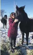  ??  ?? Former Alberta resident Kathy O’Reilly with her two horses, which were allegedly stolen and sold to a slaughterh­ouse.