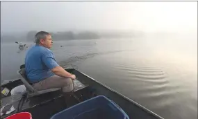  ?? NWA Democrat-Gazette photograph by Flip Putthoff ?? Chris Gueydan savors the quiet and scenery of dawn on Bob Kidd Lake.