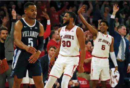  ?? ADAM HUNGER — THE ASSOCIATED PRESS ?? St. John’s guard LJ Figueroa (30) celebrates a three-point basket in front of Villanova guard Phil Booth (5) during the second half of an NCAA college basketball game Sunday in New York.