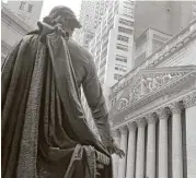  ?? Richard Drew / Associated Press file ?? A statue of George Washington at Federal Hall faces the facade of the New York Stock Exchange.