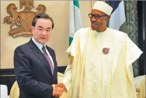  ?? ZHANG BAOPING/ XINHUA ?? Foreign Minister Wang Yi meets with Nigerian President Muhammadu Buhari in Abuja, capital of Nigeria, on Thursday.