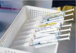  ?? JAE C. HONG/AP ?? President-elect Joe Biden will end holding back the most available COVID-19 vaccines. Above, syringes with the Pfizer-BioNTech vaccine at a hospital in Orange, California.