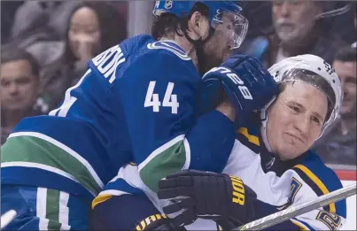  ?? The Canadian Press ?? Vancouver Canucks defenceman Erik Gudbranson (44) shoves St. Louis Blues forward Alexander Steen into the boards during first-period NHL action in Vancouver on Thursday night. The Canucks won 5-1.