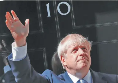  ?? AP/FRANK AUGSTEIN ?? Britain’s new Prime Minister Boris Johnson waves from the steps outside 10 Downing Street.