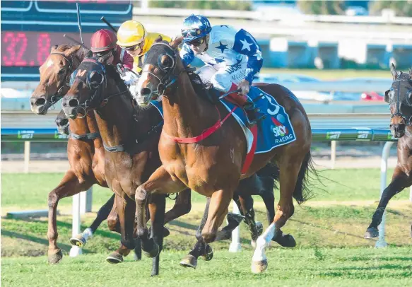  ?? Picture: TRACKSIDE PHOTOGRAPH­Y ?? Crack Me Up (blue and white silks) takes out the Tatt’s Mile at Doomben during the winter carnival.