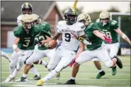  ?? JAMES BEAVER/FOR MEDIANEWS GROUP ?? Lansdale Catholic defenders close in around McDevitt’s Lonnie Rice (9) for a big sack Saturday afternoon at Wissahicko­n High School.