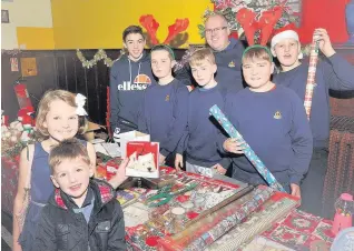  ??  ?? Christmas cheer
Boys Brigade members at the Flemington Hallside Christmas mega fayre