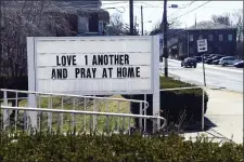  ?? JACQUELINE DORMER — THE REPUBLICAN-HERALD VIA AP ?? Sign asking to love one another and pray at home in front of St. James Episcopal Church on Dock Street in Schuylkill Haven, Pa., on Sunday.