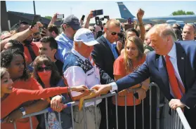  ?? Mandel Ngan / AFP / Getty Images ?? President Trump greets supporters at a Milwaukee airport. Trump in 2016 became the first Republican to win Wisconsin since Ronald Reagan in 1984.