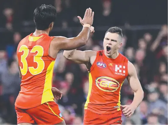  ?? Picture: AAP IMAGE ?? Ben Ainsworth (right) celebrates after kicking a goal at Metricon Stadium last year. He hopes for many more this year in a new midfield role.