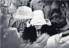  ??  ?? You’ll grow into it: a child tries on a hat for sale in a Manchester department store, 1968