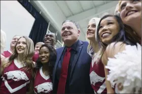  ?? (NWA Democrat-Gazette/Charlie Kaijo) ?? Arkansas football Coach Sam Pittman stands with cheerleade­rs after his introducto­ry news conference on Dec. 9. Pittman starts his first season as the head coach at Arkansas after spending the previous four seasons as the offensive line coach at Georgia.