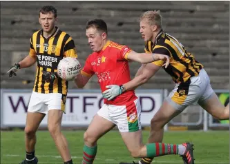  ??  ?? Ryan Mahon of Starlights is tackled by Shelmalier­s full-forward A.J. Lehane.