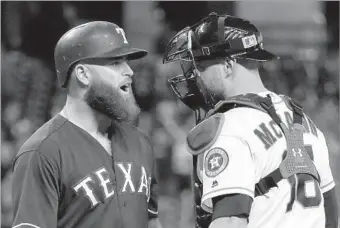  ?? David J. Phillip Associated Press ?? MIKE NAPOLI, left, of the Texas Rangers and Brian McCann of the Houston Astros exchange words after Lance McCullers threw a fastball behind Napoli in during a game in early May.