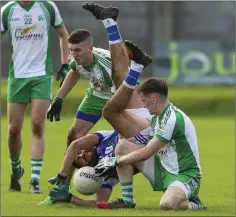  ??  ?? Éire Óg’s Darren Hayden is upended by Baltinglas­s’s Dan Kelly.