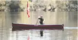  ?? TROY FLEECE ?? A canoeist with a Unifor flag paddled around Wascana Lake Wednesday as a union motorcade circled the Legislativ­e Building.