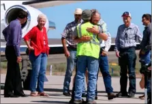  ??  ?? Rancher Dwight Hammond Jr. (center) is embraced after arriving by private jet at the Burns Municipal Airport on Wednesday, in Burns, Ore. BeTH NAkAMURA/THe OReGONIAN VIA AP