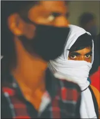  ?? (AP/Manish Swarup) ?? Migrant workers wait to get their covid-19 tests done as they return to look for jobs in New Delhi, India. India’s pandemic assistance has amounted to only about 1% of its GDP, Nobel laureate Abhijit Banerjee said, compared with the U.S.’s package in March of about 10% of its GDP.