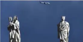  ??  ?? THE VATICAN: An airplane of the Irish low-cost airline Ryanair is seen in the sky above statues of the Vatican. Irish no-frills carrier Ryanair charted a course to higher profits last year, despite tough trading on the back of Britain’s shock Brexit...