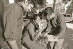  ?? ABHIJIT BHATLEKAR/MINT ?? Two young innovators test a woman's haemoglobi­n levels on a device they have invented in Thane, Maharashtr­a