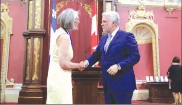  ?? COURTESY ?? TBL resident and author Louise Penny became an officer of the Order of Quebec last Friday. Premier Philippe Couillard was at the National Assembly to award the insignia.